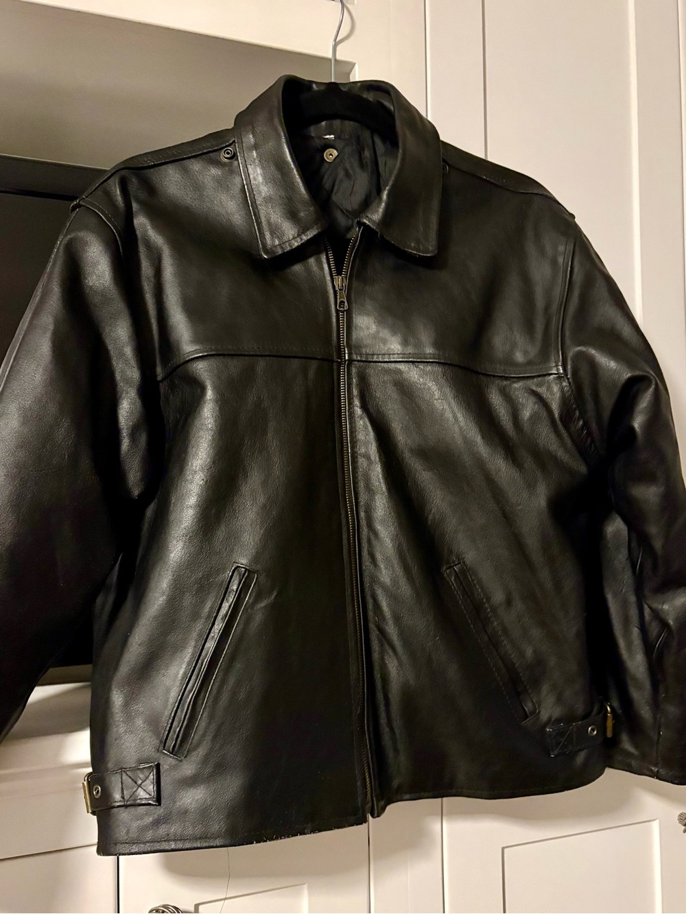 Vintage men’s black leather biker jacket with “Fiocchi Italy” snap fasteners